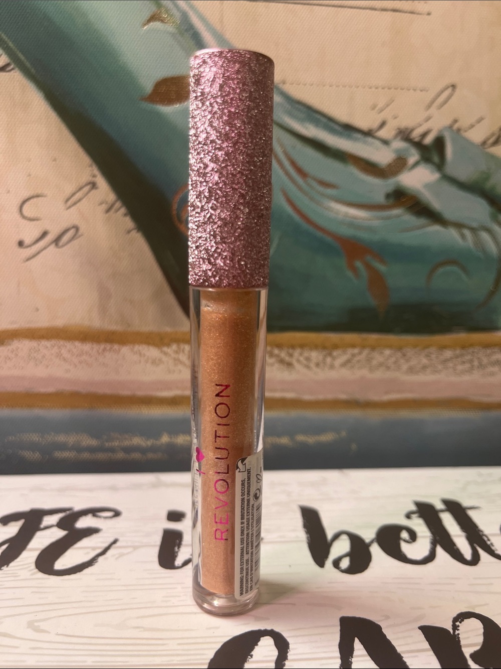 Revolution Metallic Bronze Liquid gloss with Pink Glitter Cap
